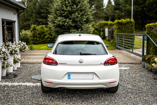 VW Scirocco white coupe sports car light painted in home backyard.