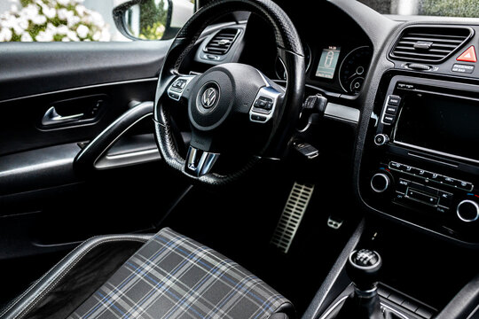 VW Scirocco interior of white coupe sports car light painted in home backyard.