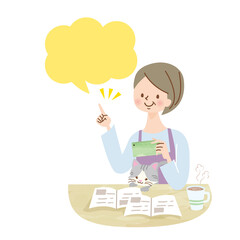 スマホを持って猫を抱っこしているミドル女性