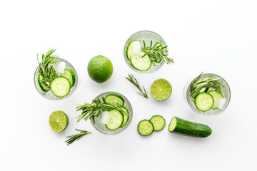 Cold soda drink with pieces of cucumber lime and herbs