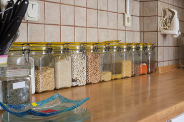 Legumes sorted in jars on the kitchen counter Selective Focus