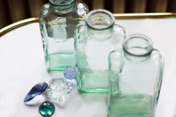 rectangular, three empty bottles and decorative ornaments. Selective Focus Stones