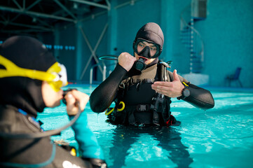 Fototapeta na wymiar Female diver and male divemaster, diving school