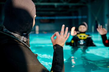 Instructor and two divers, course in diving school