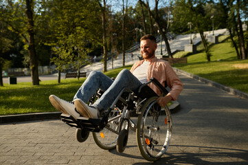 Fototapeta na wymiar Young man in wheelchair shows his skill