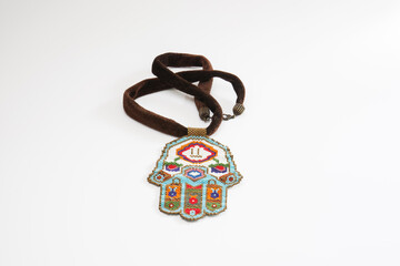 Velvet cord necklace decorated with beads. Anatolian rug motifs isolated white background