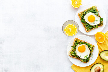 Sadwich with avocado eggs and spinach on toasted bread