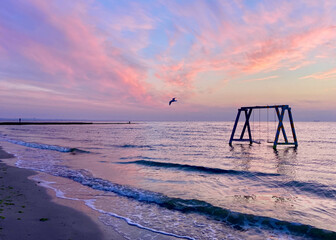 Swing near the sea at sunset 