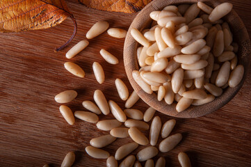 Pine nut grains on wooden background