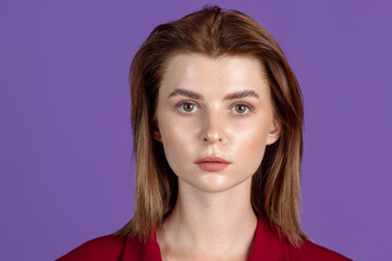 Fototapeta premium Close-up portrait of young girl isolated on purple, lilac color studio background. Concept of human emotions, facial expression, cosmetics, youth