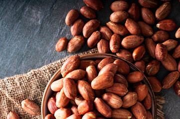 Unshelled and healthy peanuts, black backround