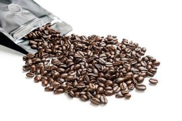 Coffee beans close-up on a white background with selective focus and copy space.