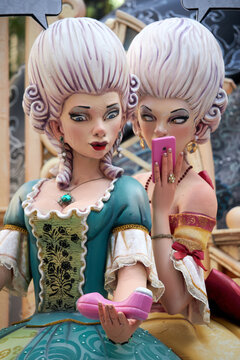 VALENCIA, SEPTEMBER- 2021: Detail of artistic figure at the popular festival known as the "Fallas" two women admire a clit sucker