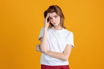 Studio shot of young pretty girl isolated on yellow color studio background. Concept of human emotions, facial expression, natural beauty, appearance, youth