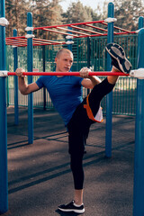 Fototapeta premium athlete doing stretching exercises workout on sports ground