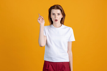 Studio shot of young cute girl isolated on yellow color studio background. Concept of human emotions, facial expression, natural beauty, appearance, youth