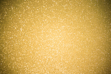 Gold glitters background. shimmering blur spot lights Bokeh Shiny gold light background.