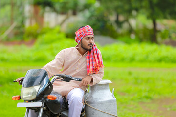 Fototapeta na wymiar Rural scene : Indian milkman distribute milk on bike