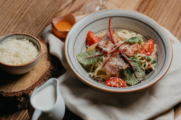 in carbonara with bacon rubbed cheese