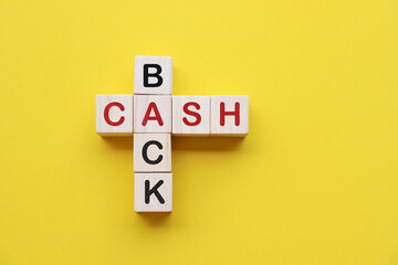Stacked wooden cubes with the word CASHBACK on pastel background. financial concept