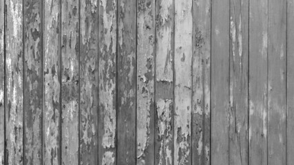 Rusty old wooden plank fence wall background in classic old black and white gray tones of a house in rural Thailand.