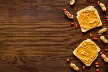 Breakfast with peanut butter sandwiches on white bread, top view