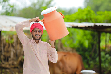 Young indian milk man at his farm