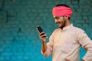 Technology concept : Indian farmer using smartphone