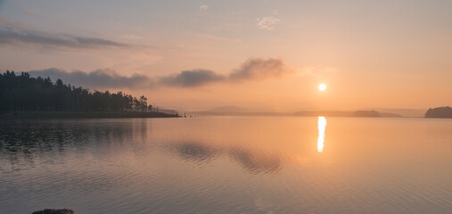 peaceful sunrise over lake