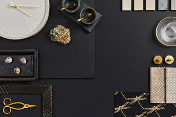 Flat lay composition of creative black architect moodboard with samples of building, textile and natural materials and personal accessories. Top view, black backgroung, template.