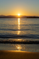 Beautiful sunrise on the shore of the blue sea, Gorgeous colorful landscape, Corfu Island, Greece