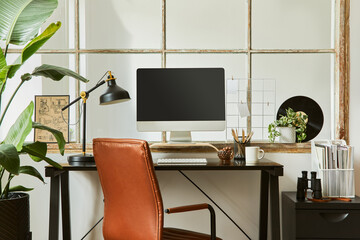 Creative composition of modern masculine home office workspace interior design with black industrial desk, brown leather armchair, pc and stylish personal accessories. Template.