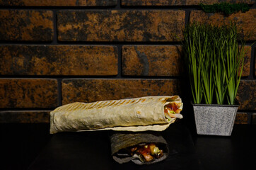 shawarma on a background of a brick wall and green space