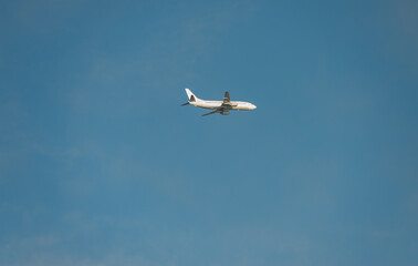 A plane is flying high in the sky