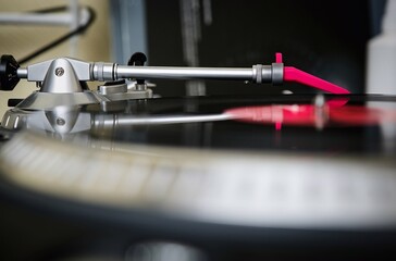 Fototapeta na wymiar Tone arm with needle on vinyl record. Professional dj turntable playing hip hop music