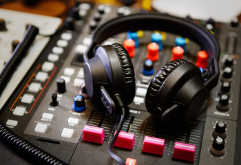 Dj headphones on sound mixer. Professional disc jockey audio equipment in sound recording studio to...