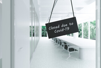 Closed due to Covid 19 office sign in an empty office