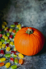 Colorful Halloween Candy and Orange Pumpkin