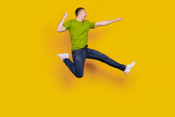 Fototapeta na wymiar Full length profile side photo of young guy angry mad fight conflict kick isolated over yellow background