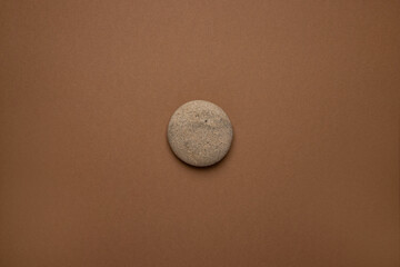 Rounded gray striped stone on brown background , trend minimal style - Powered by Adobe