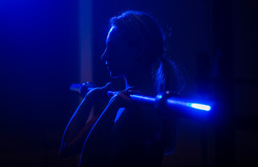 Cross fit training. Muscular woman with barbell. Sporty girl squats with barbell training. Sport, bodybuilding, lifestyle concept. Fit young woman in great shape lifting barbells. Silhouette