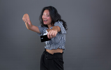 young chinese brunette offering card with direct look and smile