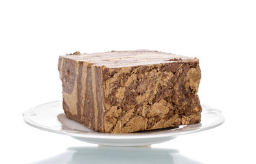 Pieces of sweet halva with chocolate on a white saucer, close-up, isolated on white.