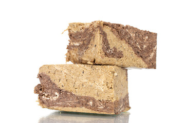 Pieces of sweet halva with chocolate, close-up, isolated on white.