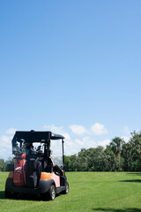 A golfer in his golf car in the golf course