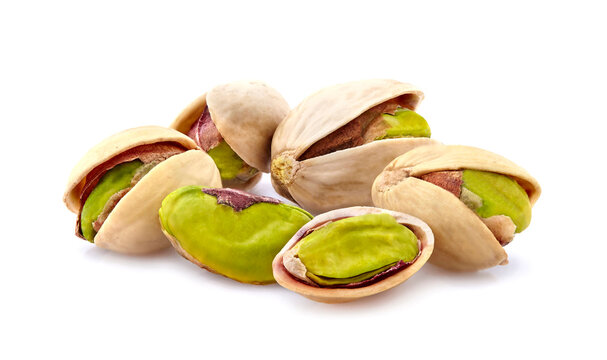 Pistachio nuts in closeup isolated on white background.