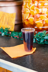 hot sangria wine with spiced in a plastic glass at the New Year's Eve christmas street fair