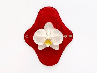 reusable sanitary napkin, eco menstruation concept, white orchid