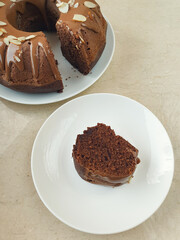 Chocolate pie one piece cutted on white round plate on marble table