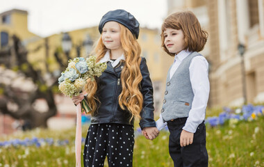 a couple of children standing on the lawn portraying themselves as adults